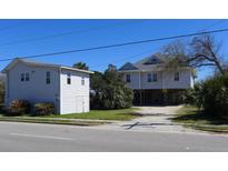 Charming coastal homes with elevated construction and lush landscaping in a beach community at 1908 Palmetto Boulevard Blvd, Edisto Island, SC 29438