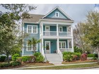 Charming two-story home featuring a spacious porch and a beautifully landscaped front yard at 2447 Louisville St, Charleston, SC 29492