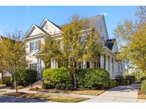 Charming two-story home boasts a landscaped yard and classic architectural details at 278 Furman Farm Pl, Daniel Island, SC 29492