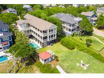 Expansive waterfront property featuring a pool, gazebo, and lush lawn at 2906 Palm Blvd, Isle of Palms, SC 29451
