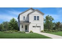 Charming two-story home featuring a modern farmhouse design with white siding, a well-manicured lawn, and a cozy front porch at 355 Claret Cup Way, Charleston, SC 29414
