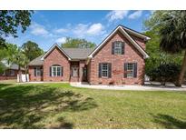 Charming brick home with well-manicured lawn and classic black shutters, blending elegance with a touch of Southern charm at 3708 Colonel Vanderhorst Cir, Mount Pleasant, SC 29466