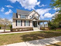 Charming two-story home featuring a welcoming front porch and beautifully landscaped front yard at 545 Two Mile Run, Johns Island, SC 29455