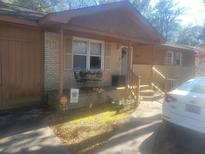 Charming front porch with brick features, a cozy seating area, and a well-maintained entryway at 1273 Mathis Ferry Rd, Mount Pleasant, SC 29464