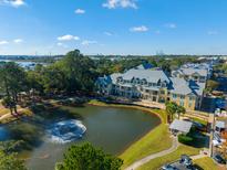Beautiful aerial view of the property featuring a serene pond and well-maintained landscaping at 130 River Landing Dr # 5208, Charleston, SC 29492