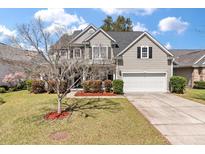 Charming two-story home with a well-manicured lawn and attached garage at 2940 Amberhill Way, Charleston, SC 29414