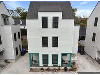 Three-story home featuring a gray roof and siding, with decorative turquoise trim on the front porch area at 3 1/2 Maranda Holmes St # B, Charleston, SC 29403