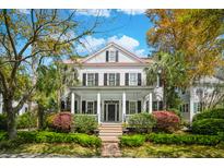 Charming two-story home features a classic front porch and manicured landscaping creating an inviting curb appeal at 34 Frogmore Rd, Mount Pleasant, SC 29464