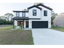 Beautiful two-story home featuring a modern farmhouse design and a spacious two-car garage at 1000 Retreat Ave, Moncks Corner, SC 29461