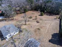 Aerial view of a single Gathering home and lot with mature trees and a large yard at 126 N Hwy 52, Moncks Corner, SC 29461