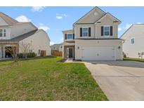 Charming two-story home featuring a well-manicured lawn, a two car garage, and inviting front entrance at 130 Hyrne Dr, Goose Creek, SC 29445
