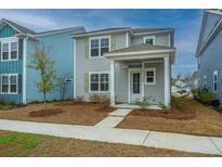 Charming two-story home with a covered porch and neutral siding, complemented by a well-maintained front yard at 143 Brant Dr, Summerville, SC 29483