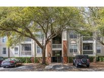 Exterior view of a multi-story apartment building with well-maintained landscaping and a tree in front at 1600 Long Grove Dr # 1226, Mount Pleasant, SC 29464