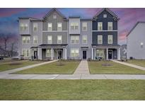 Charming row of townhomes with manicured lawns offers curb appeal and comfortable living at 861 Recess Point Dr, Moncks Corner, SC 29461