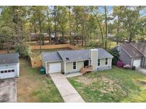 Ranch style home featuring an attached garage, a new fence, and a landscaped front yard at 109 Sawmill Dr, Summerville, SC 29483