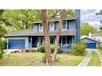 Charming two-story home with a welcoming front porch, garage and beautiful blue siding at 1438 Arrow Wind Ter, Charleston, SC 29414
