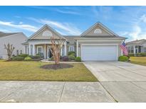 Charming single-story home with manicured lawn, tidy landscaping, covered porch, and attached two-car garage at 145 Billowing Sails St, Summerville, SC 29486