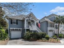 Charming two-story home boasts landscaped yard, white trim, and an inviting entrance at 1501 Sea Palms Cres, Mount Pleasant, SC 29464