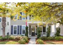 Charming two-story home featuring a welcoming front porch and lush landscaping at 1870 Carolina Bay Dr, Charleston, SC 29414