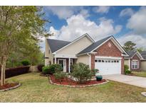 Charming single-Gathering home with a well-manicured lawn and a two-car garage and brick front at 201 Island Green Rd, Goose Creek, SC 29445