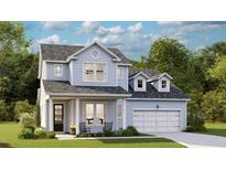 Charming two-story home with light blue siding, a front porch, and a well-manicured lawn at 215 Denham St, Summerville, SC 29486