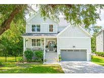 Charming two-story home with a welcoming front porch, manicured lawn, and a two car garage at 2218 Sunstone Ct, Charleston, SC 29412