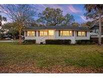 Charming single story home with a lush front lawn and beautiful trees at 3304 Hartnett Blvd, Isle of Palms, SC 29451