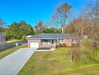 Charming single-story brick home featuring a well-manicured lawn and a large driveway at 3552 Old Ferry Rd, Johns Island, SC 29455