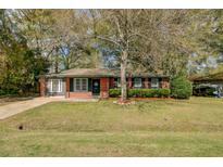 Charming single-story brick home with a well-maintained front yard and mature tree at 4418 Hardwood St, Ladson, SC 29456