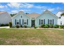 Charming one-story home with an inviting exterior, well-manicured lawn, and beautiful landscaping at 5509 Alpine Dr, Summerville, SC 29483