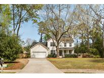Charming two-story home featuring a lush front yard, a covered porch, and a paved driveway at 639 Bridlewood Ln, Mount Pleasant, SC 29464
