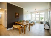 Bright living room with hardwood floors, neutral paint, and a large window showcasing natural light at 135 Pier View # 305, Charleston, SC 29492