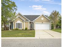 Charming single-story home with a well-manicured lawn and a two-car garage at 1537 Sweet Myrtle Cir, Mount Pleasant, SC 29466