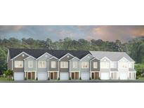 New townhomes showing exterior elevation in a variety of neutral colors, with a tree-lined horizon at 166 Yarrow Way, Moncks Corner, SC 29461