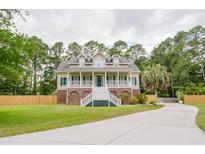 Charming two-story home with a large front porch and well-maintained lawn at 187 Pecan Dr, Summerville, SC 29483