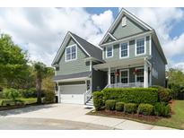 Charming two-story home with green siding, front porch, and well-manicured landscaping at 2160 Pentland Dr, Charleston, SC 29412