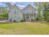 Charming two-story home featuring an inviting front porch, well-manicured lawn, and classic architecture at 3805 Adrian Way, Mount Pleasant, SC 29466