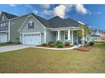 Charming single-Gathering home featuring a manicured lawn, attached garage, and a welcoming front porch at 603 Dunswell Dr, Summerville, SC 29486