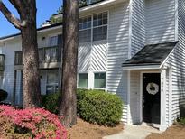 Charming two-story home with a manicured lawn and welcoming front door at 7870 Nummie Ct, North Charleston, SC 29418