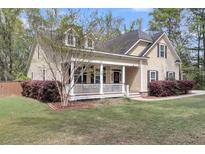Charming home with a welcoming front porch, manicured lawn, and fresh landscaping at 8618 Mcchune Ct, North Charleston, SC 29420