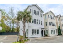 Charming three-story home with white siding, black shutters, and a well-maintained yard at 975 Warrick Oaks Ln, Mount Pleasant, SC 29464