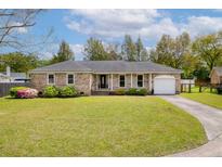 Charming single-story brick home with a manicured lawn and attached one car garage at 1109 Lee Shore Ln, Mount Pleasant, SC 29464