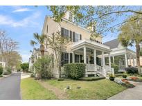 Charming two-story home with a well-manicured lawn, lush landscaping, and a welcoming front porch at 12 Leeann Ln, Mount Pleasant, SC 29464