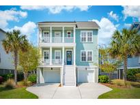 Inviting two-story coastal home with double porches, white trim, manicured lawn, and two-car garage at 1479 Mossy Branch Way, Mount Pleasant, SC 29464
