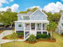 Charming two-story home featuring a welcoming front porch and beautifully landscaped front yard at 1529 Tomato Farm Cir, Mount Pleasant, SC 29464