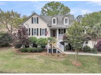 Charming home featuring a welcoming front porch, manicured landscaping, and classic architectural details at 2093 Rookery Ln, Charleston, SC 29414