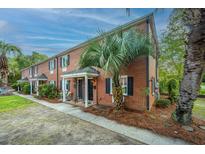 Charming brick townhomes with black shutters and mature palm trees offering curb appeal at 21 Hester St # Apt 12, Charleston, SC 29403