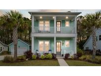 Inviting two-story home with double porches, palm trees, and lush landscaping at 2632 Private Lefler Dr, Johns Island, SC 29455