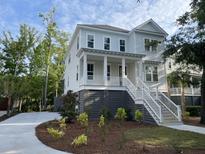 Beautiful two-story home with a front porch, manicured landscaping, and a concrete driveway at 295 W Coleman Blvd, Mount Pleasant, SC 29464