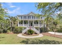 Charming two-story home with a grand entrance, white railings, and a beautifully landscaped front yard at 3734 St Ellens Dr, Mount Pleasant, SC 29466